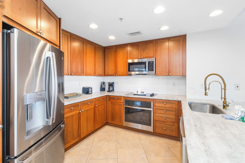 Your fully equipped kitchen features stainless steel appliances, elegant cabinetry, and everything you need to prepare meals at home during your stay.