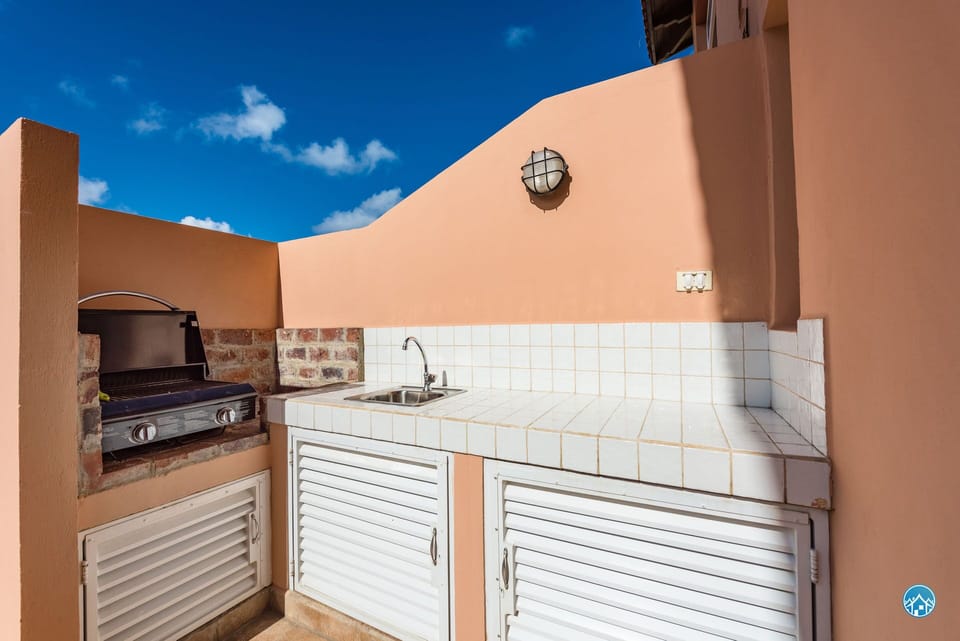 The front patio has a small outdoor kitchen with BBQ!