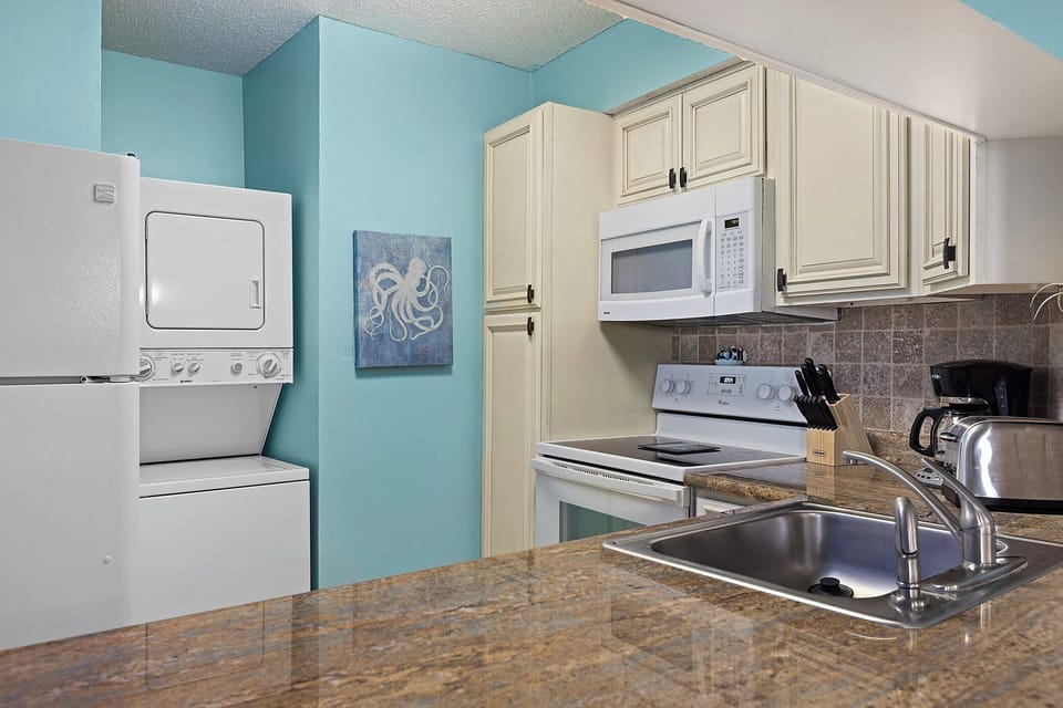Kitchen Area Inlcudes Stacked Washer and Dryer