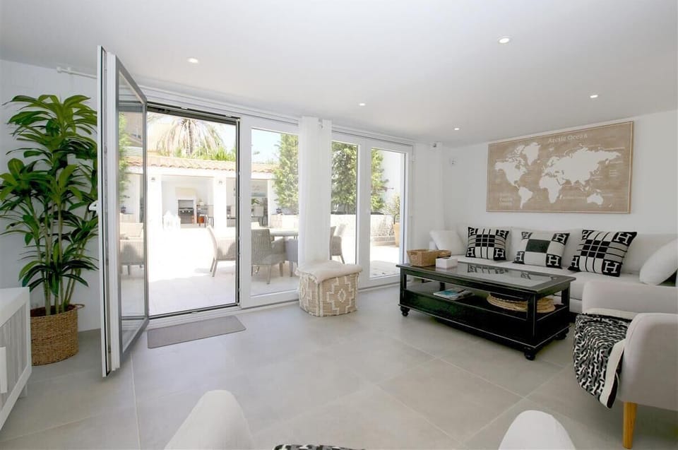 Lounge area from another angle with access to the terrace and pool