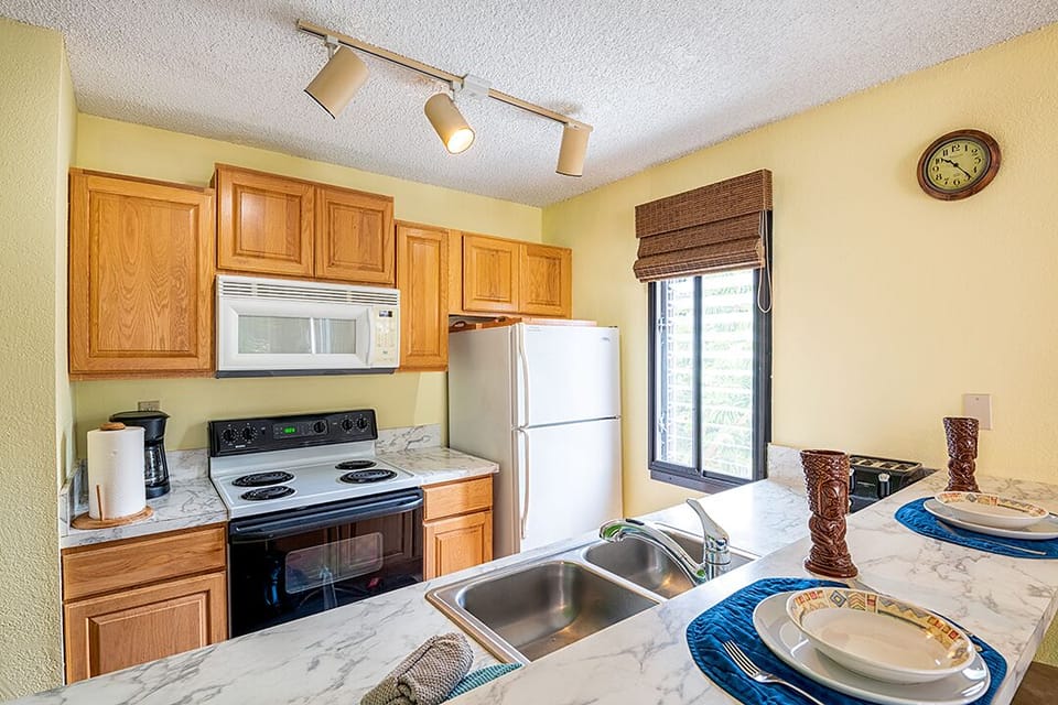This full-size kitchen includes everything you need — appliances, cookware, and dishes — ideal for quick meals or full dinners.