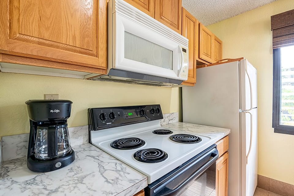 This full-size kitchen includes everything you need — appliances, cookware, and dishes — ideal for quick meals or full dinners.
