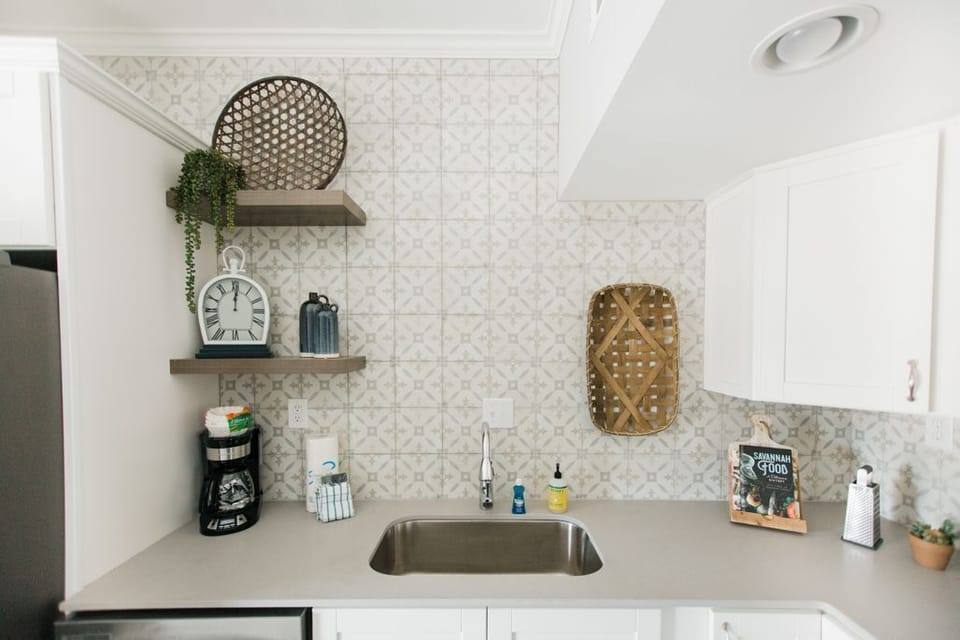 Mosaic tile is carried up to the ceiling to keep the design flowing.