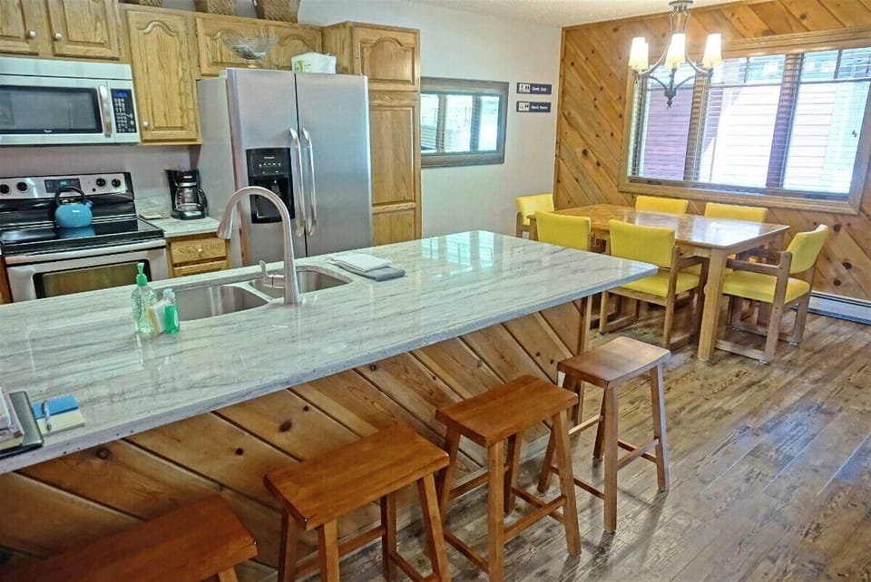 The kitchen is fully equipped and has bar seating for 4