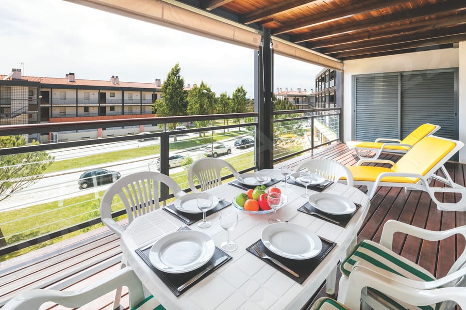 Private balcony with outdoor dining table overlooking the Marina Park resort gardens in Lagos, Algarve