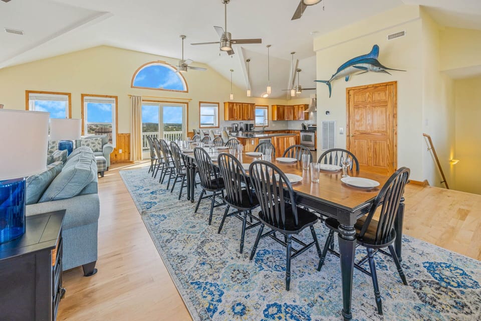 Savor the day's fresh catch at the 16-person dining table, directly adjacent to the kitchen.