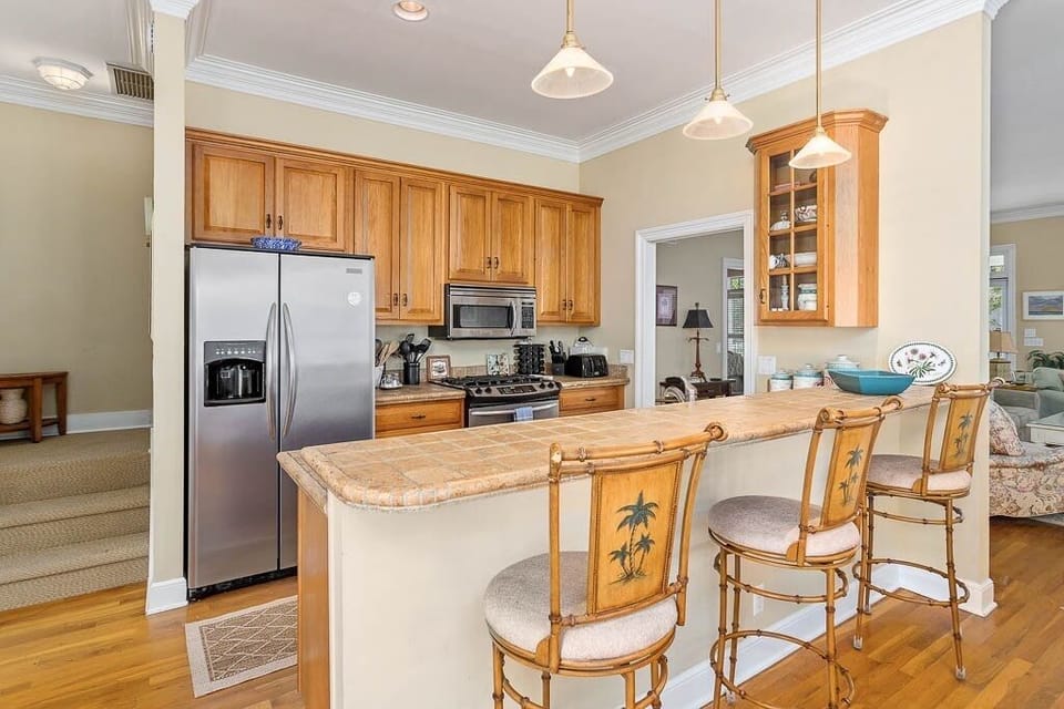 Modern Kitchen with counter stools and adjacent dining area.