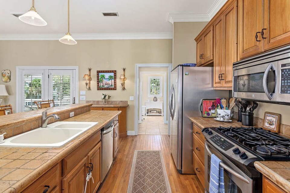 The kitchen is fully equipped with a large laundry/pantry overlooking the pool