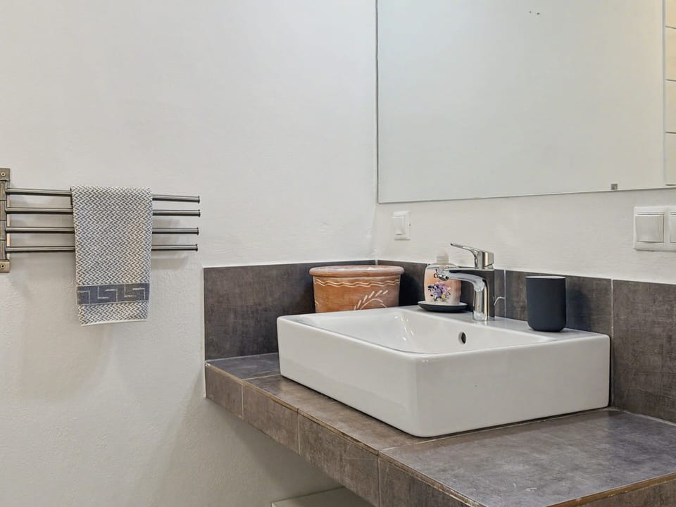 Sleek bathroom with modern sink and essential comforts for each guest.