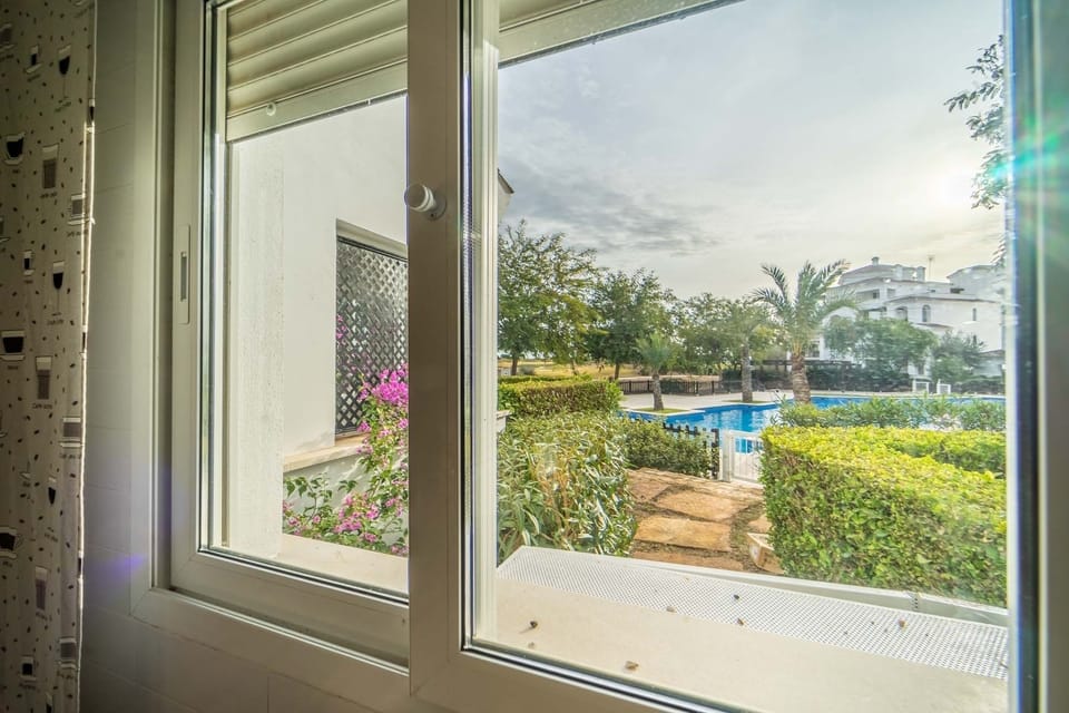 The view from the kitchen window to the pool