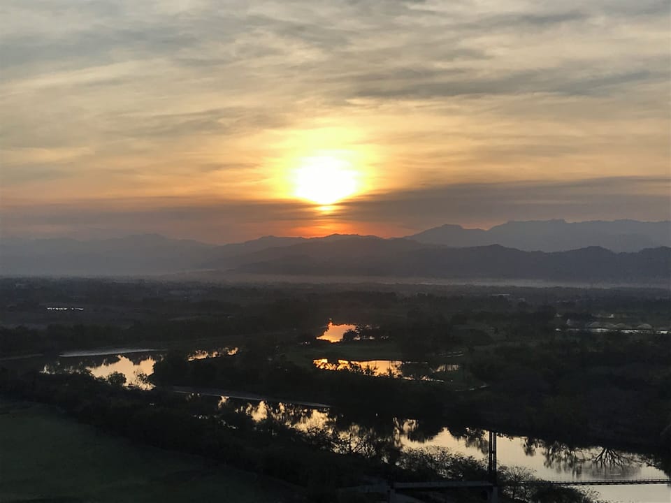 Sunrise over the mountains from Grand Luxxe Sky Lounge 