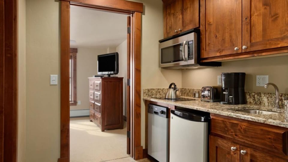 Suite galley kitchen looking into suite bedroom