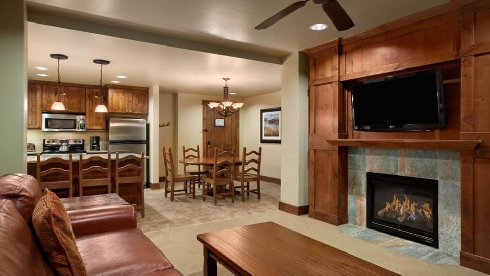 Main living room with gas fireplace and flat screen.  Full kitchen and dining.