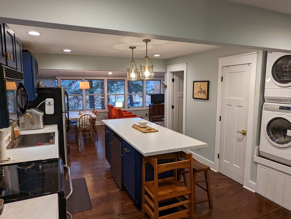 Washer and dryer, pantry door, icemaker and wide open floor plan with view