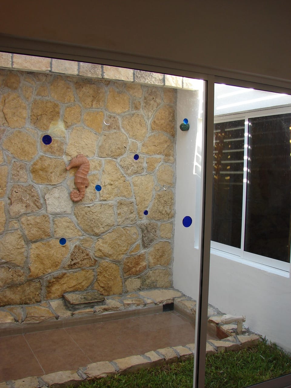 waterfall in center of house cools the humid air