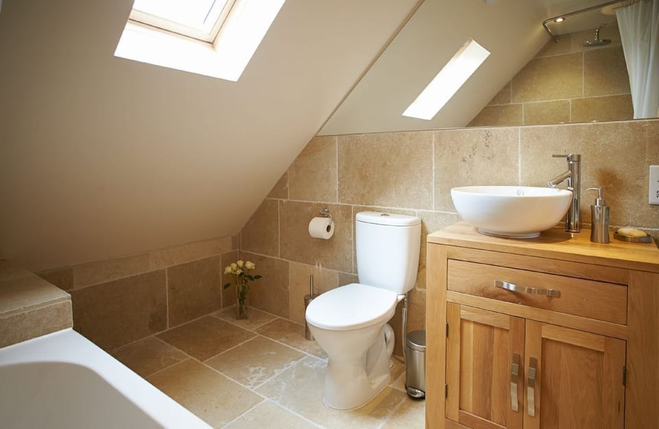 First floor:  En-suite bathroom with shower over bath