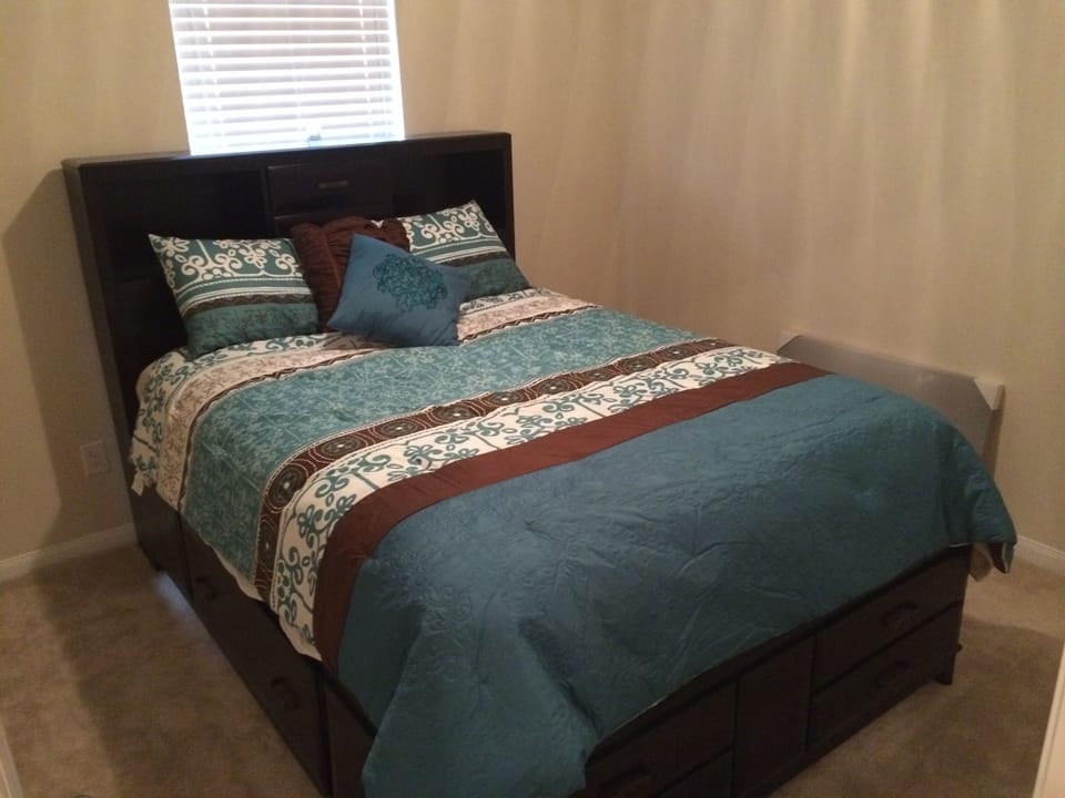 guest bedroom #1 with storage queen size bed