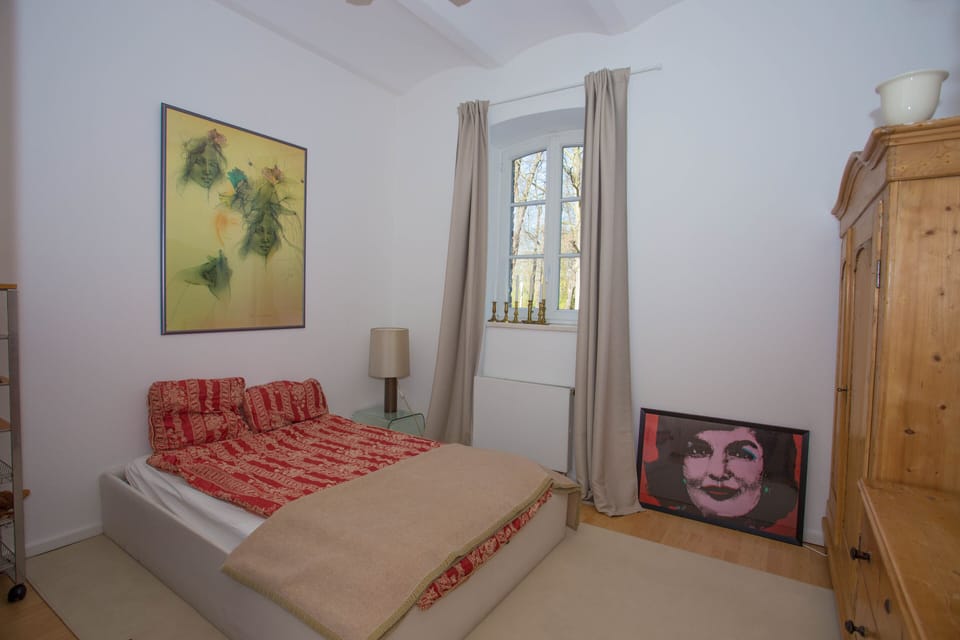 Double bed with moat view and sound of running water outside.