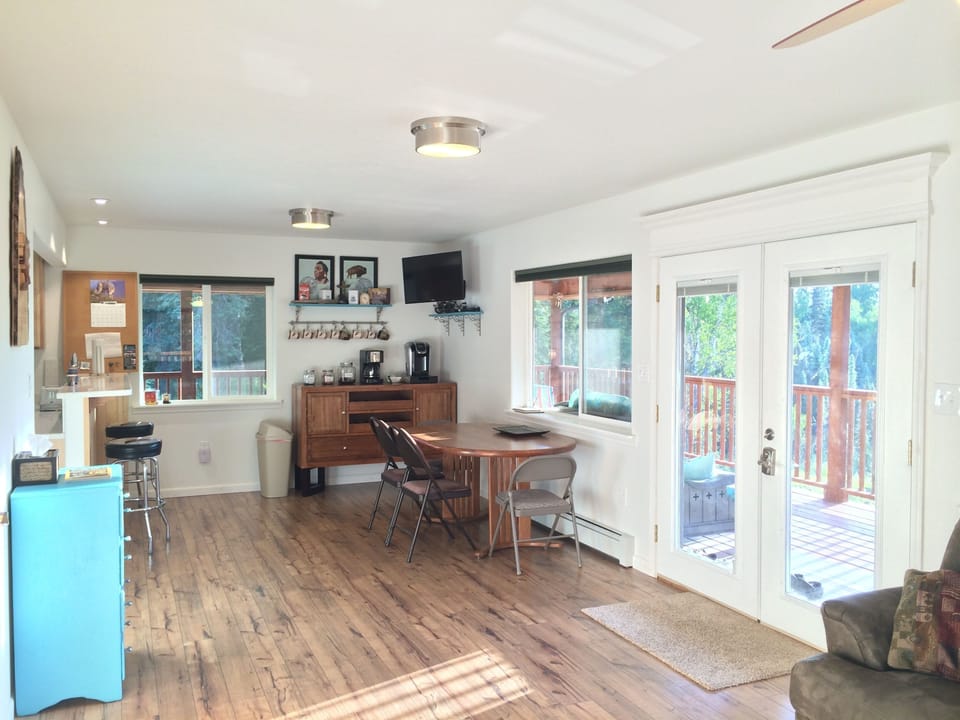 Morning sun comes through the french door that leads to a wrap-around deck
