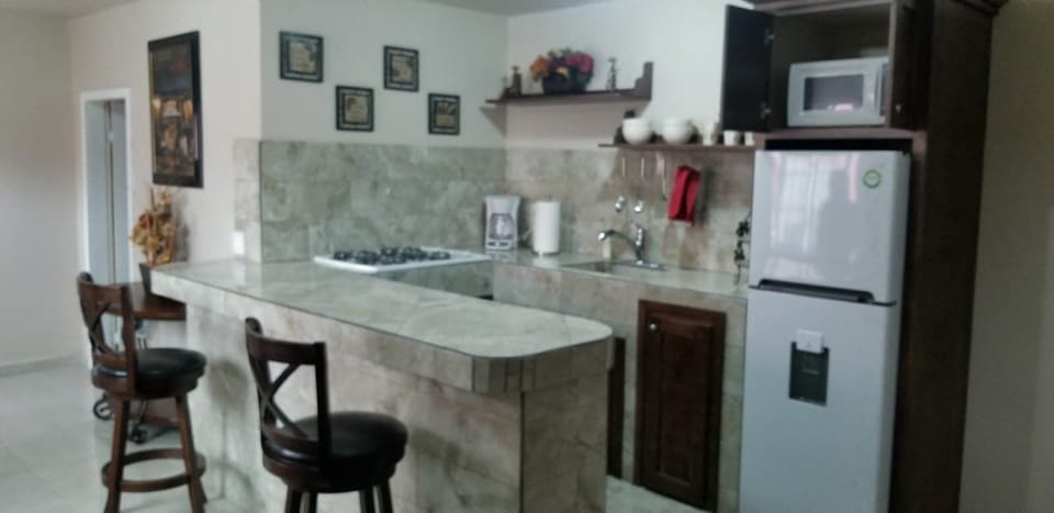 Kitchen with stove, refri and micro