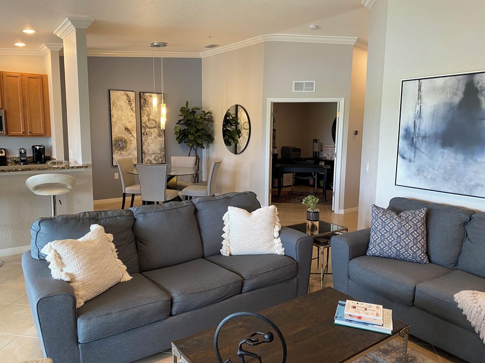 The open-concept design connects the living room, dining nook, and office.