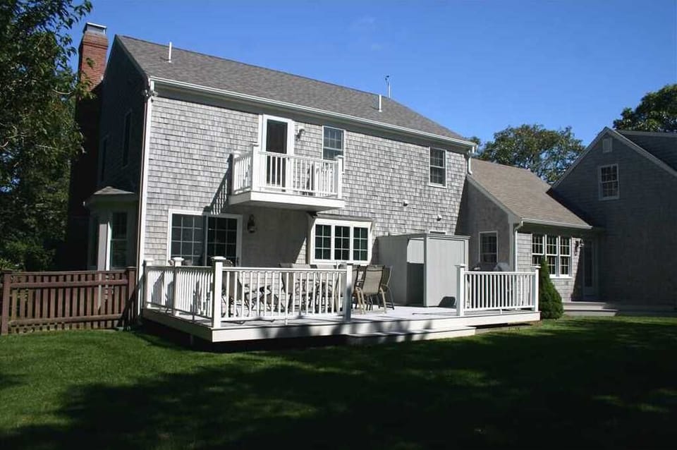 Rear View of House with Deck and Second Floor Balcony