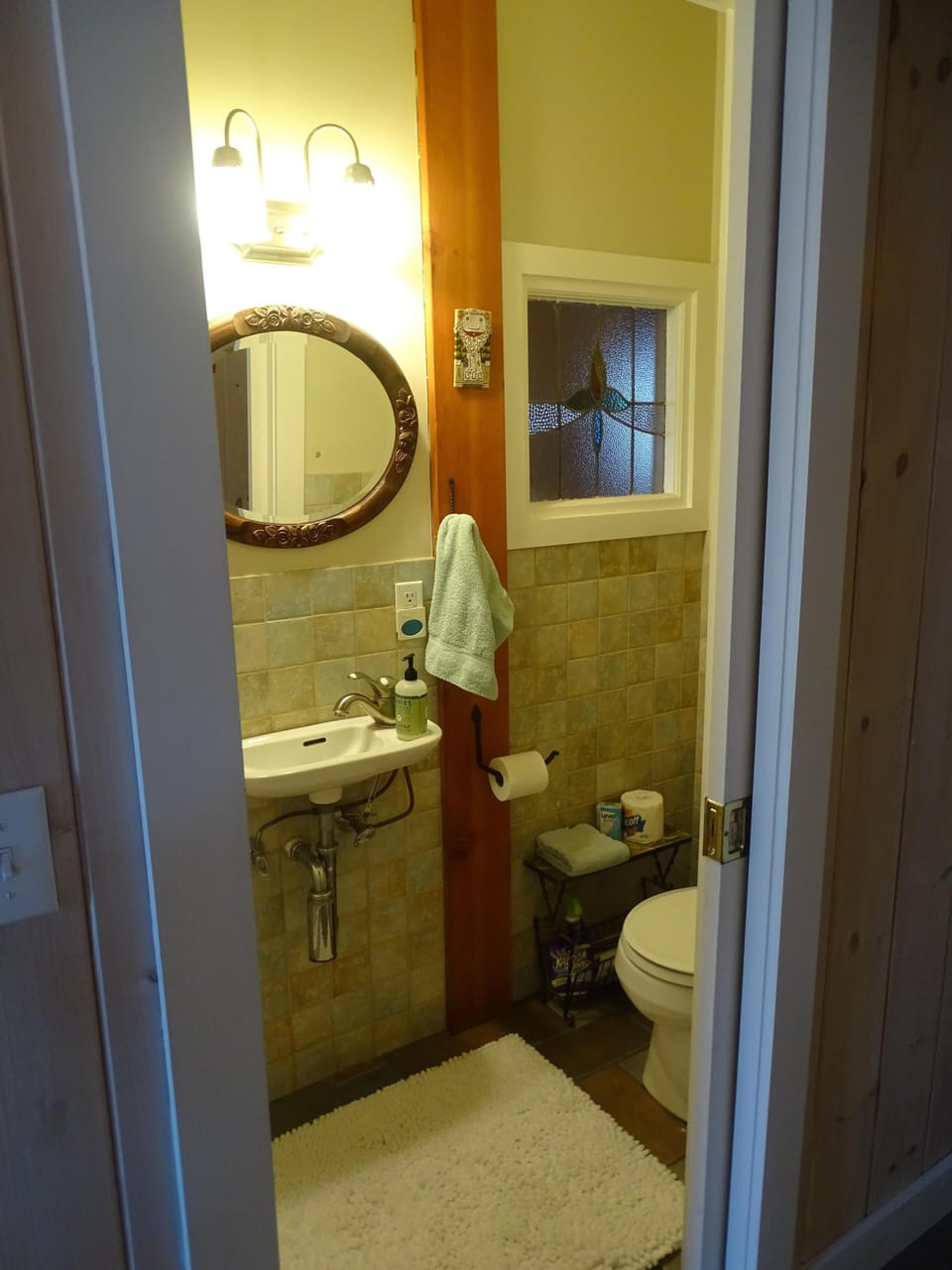 Downstairs bath with internal stained glass window. 