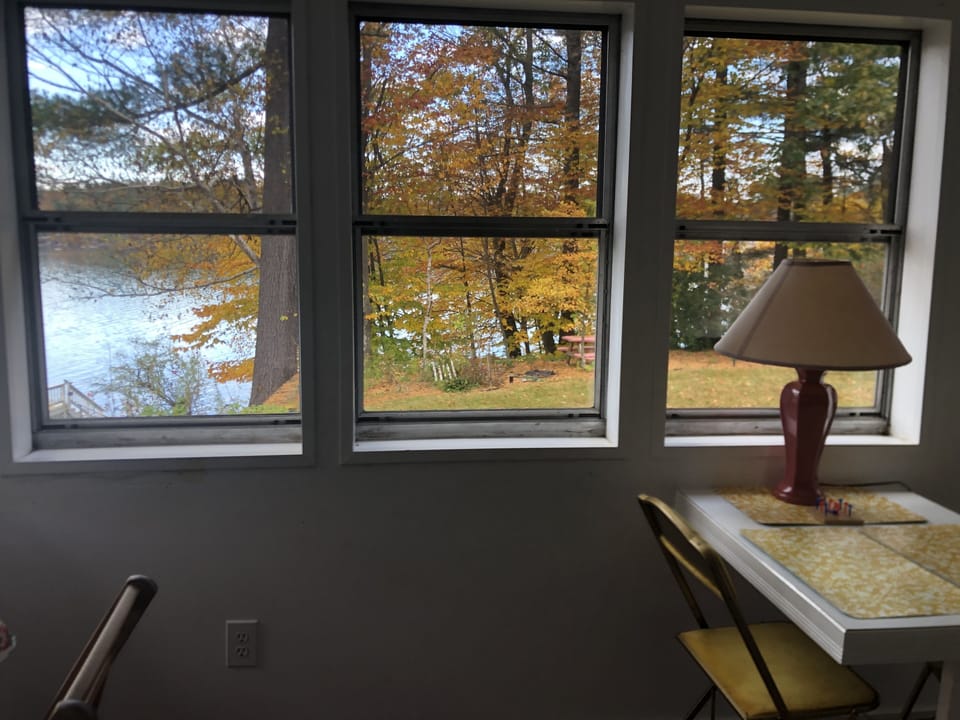 Cottage overlooks lake and gardens. Path to private waterfront area with firepit