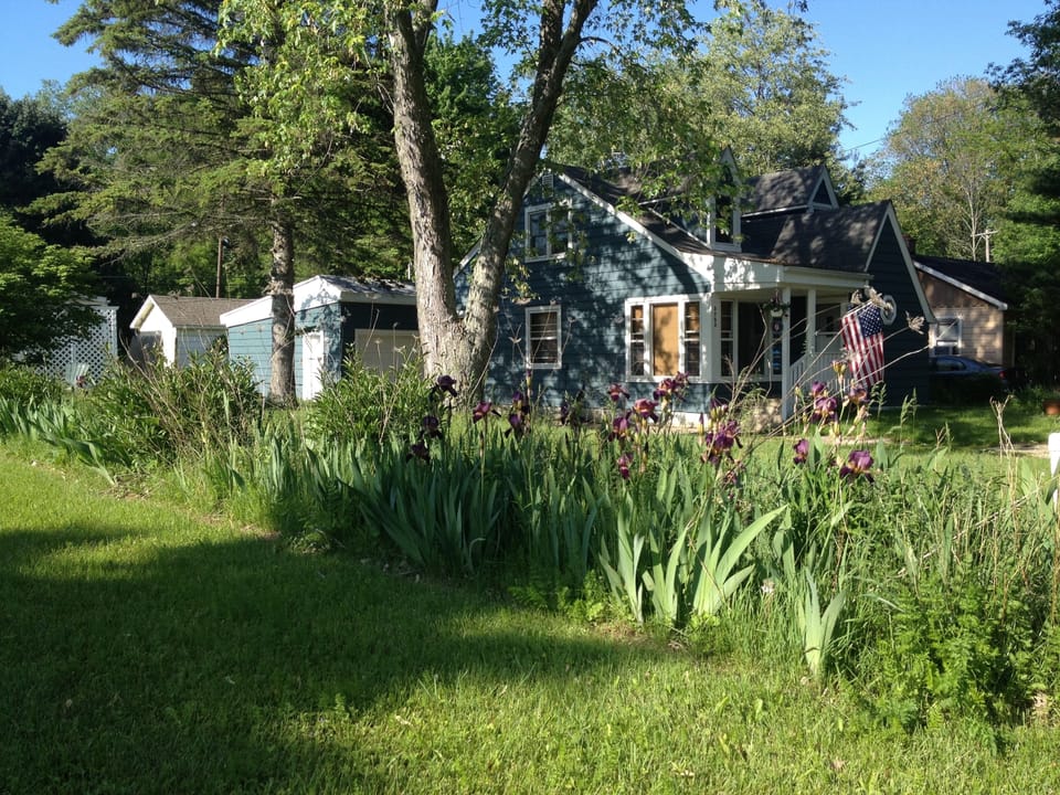 Home viewed from west to east (flowers are property line).