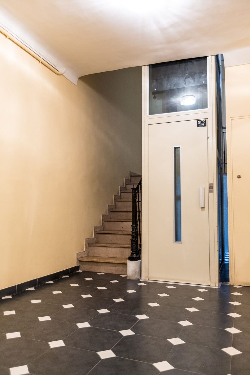 Building entrance with a modern elevator.