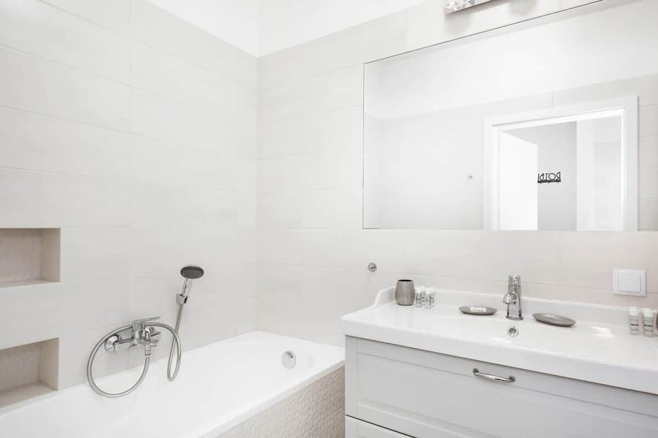 Bright bathroom with towels and shower cabin. 