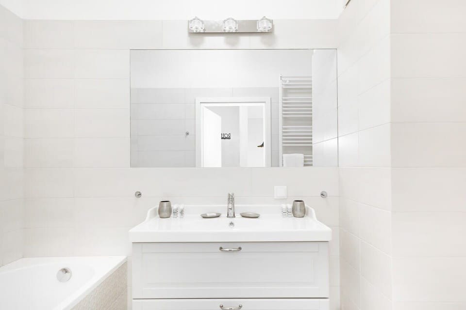 Bright bathroom with towels and shower cabin. 