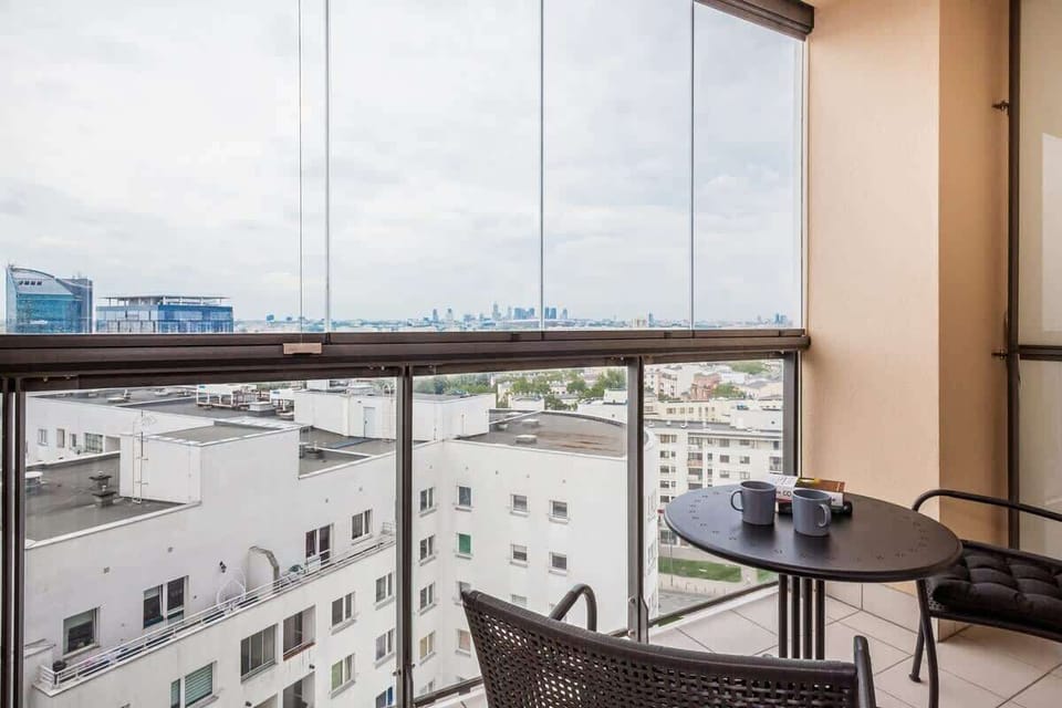Spacious balcony with outdoor furniture. 