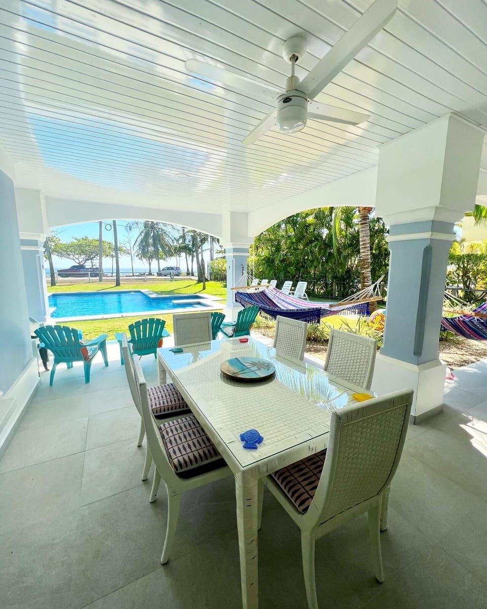 Covered terrace looking over the pool to the beach