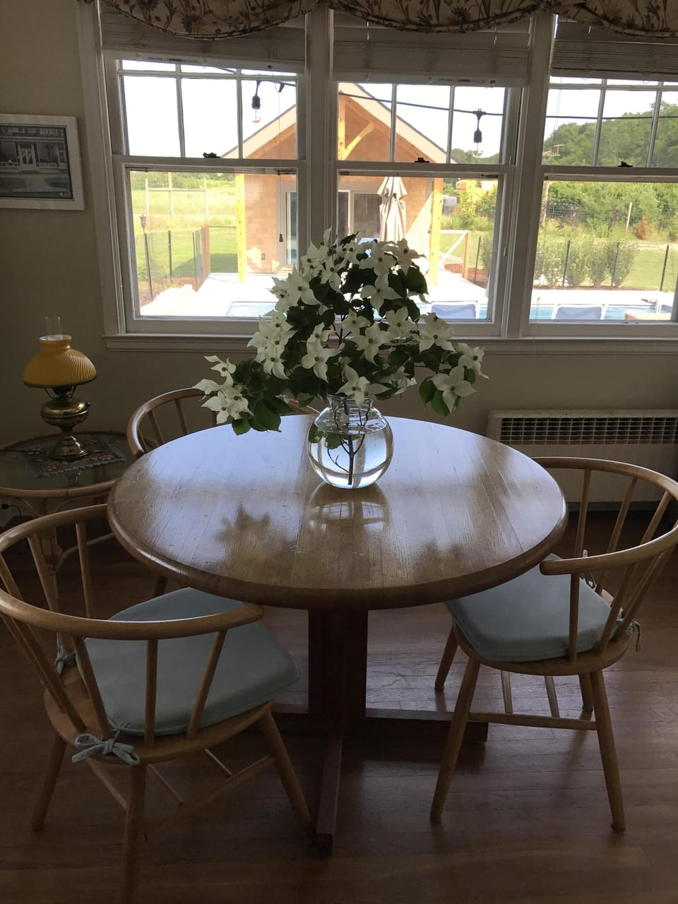Sun room with pool house in background