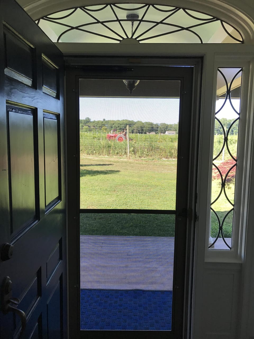 Front door and covered porch view of farm
