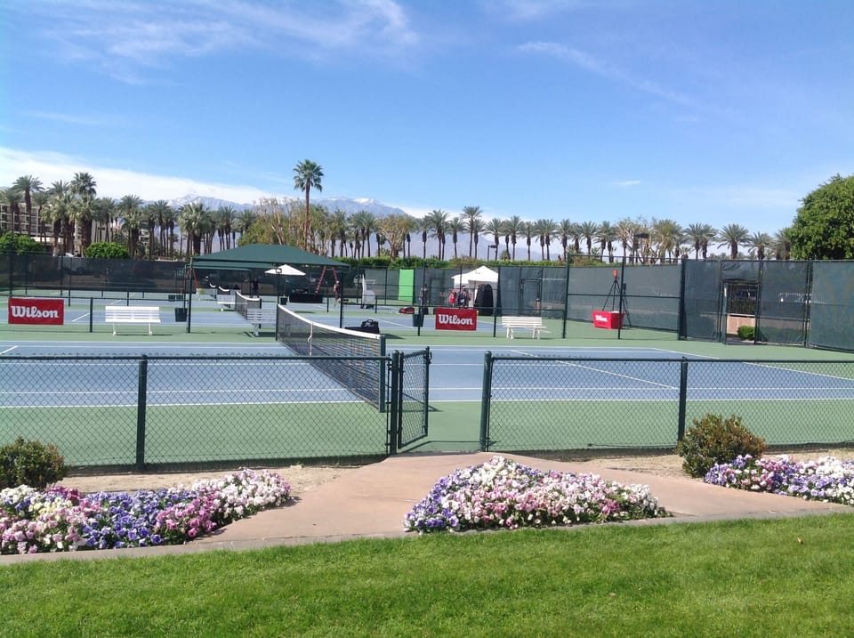 many paved tennis courts, some clay and two grass