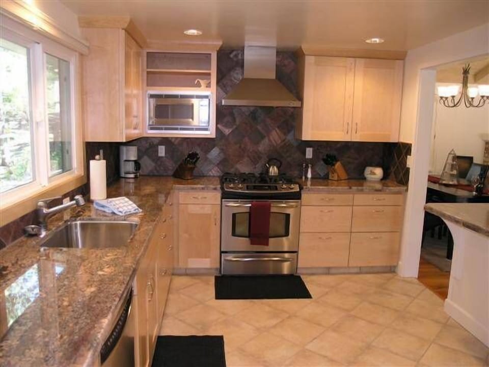 Remodeled gourmet kitchen with granite countertops and custom maple cabinets.