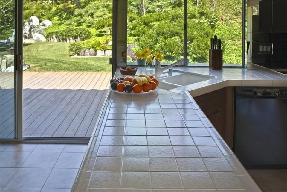 Kitchen counter with view of the garden and large redwood deck.
