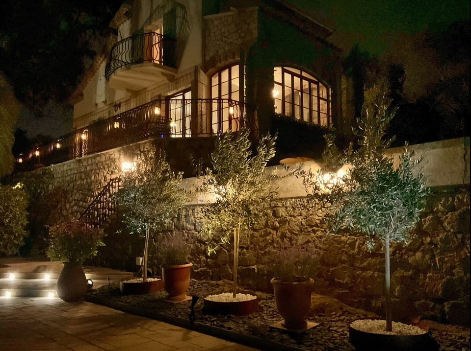 The house and gardens are beautifully lit at nighttime