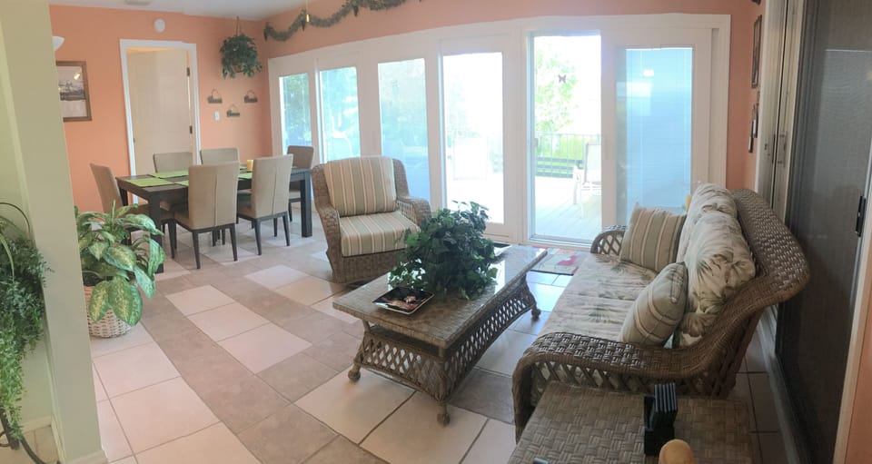 Florida room leads out to deck and view of wetlands