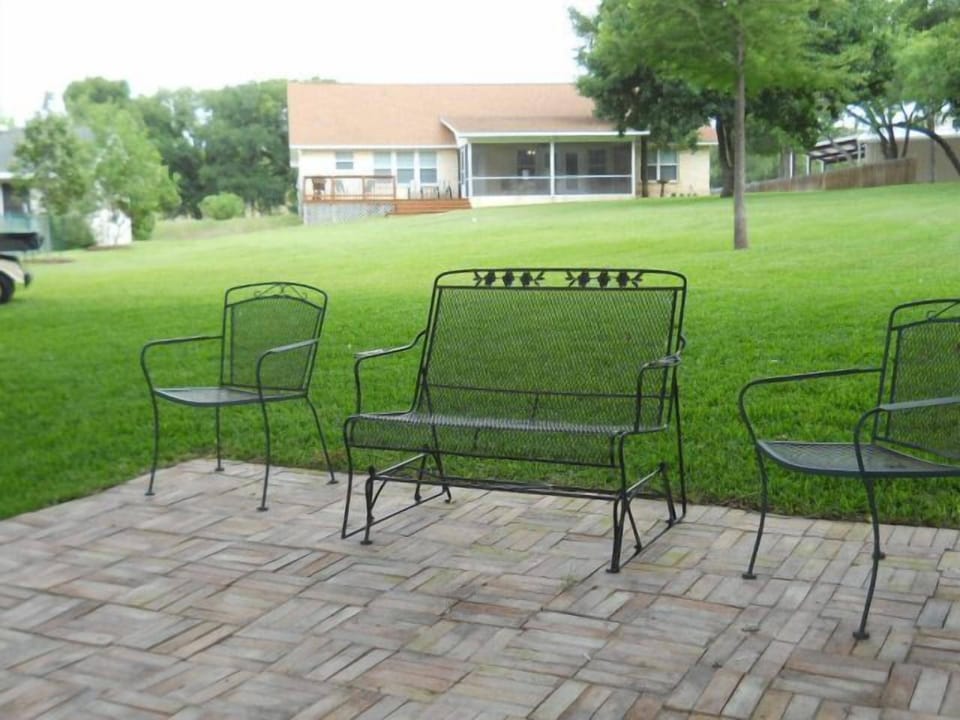 Back of home with seating area by the lake.