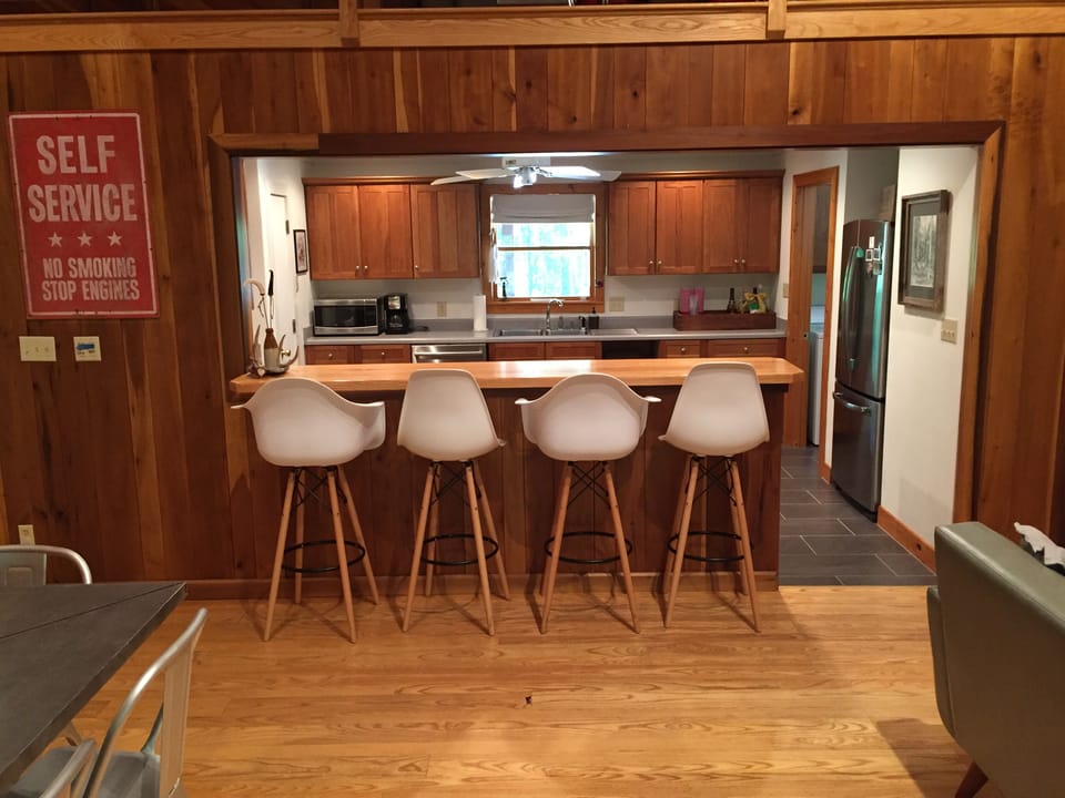 Bar area looking into kitchen!  4 Eames style barstools.  Very comfortable!