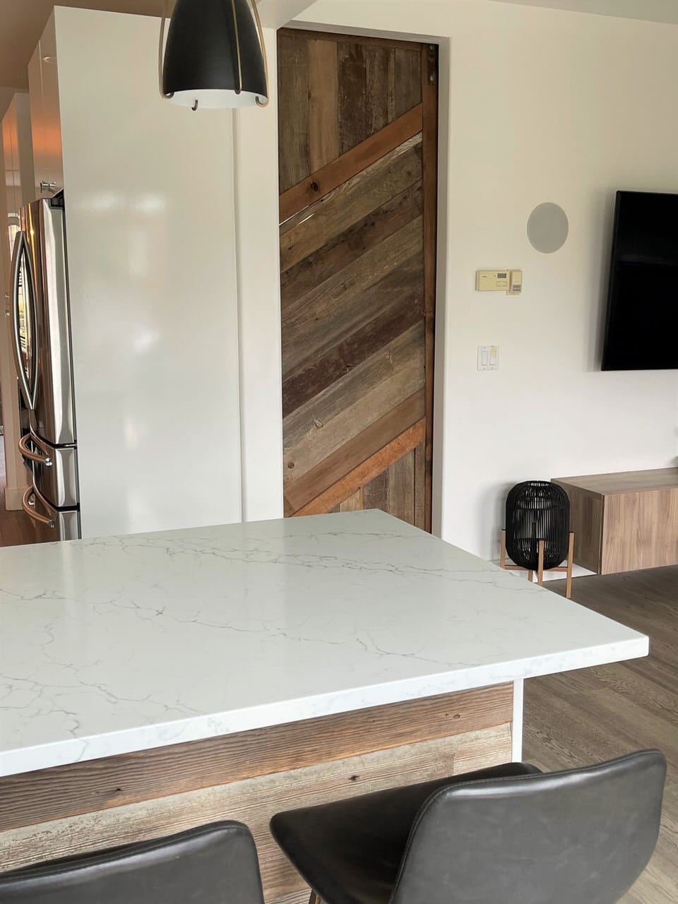 looking back from deck into kitchen / TV room. Barn door slides for quiet