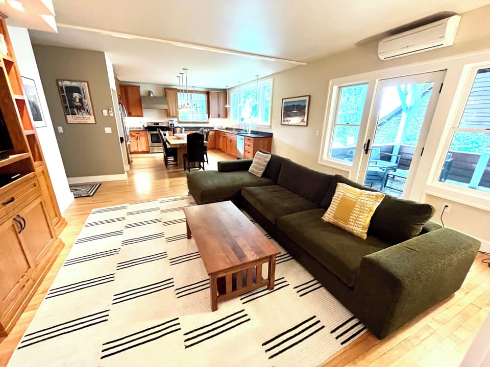 Spacious sectional in living room with big screen TV and access to patio