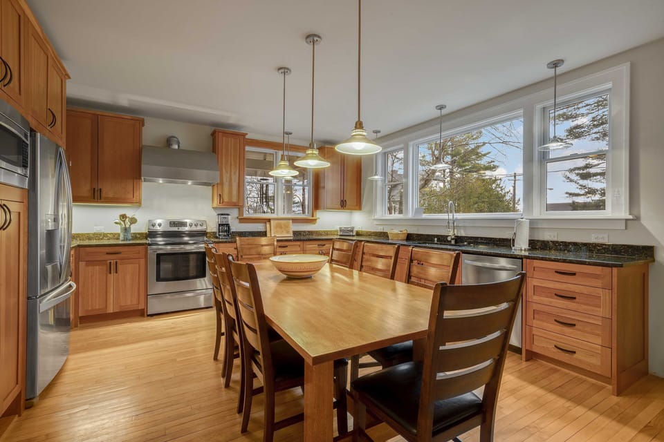 The beautiful kitchen area,  with plenty of windows, light and a table for 8!
