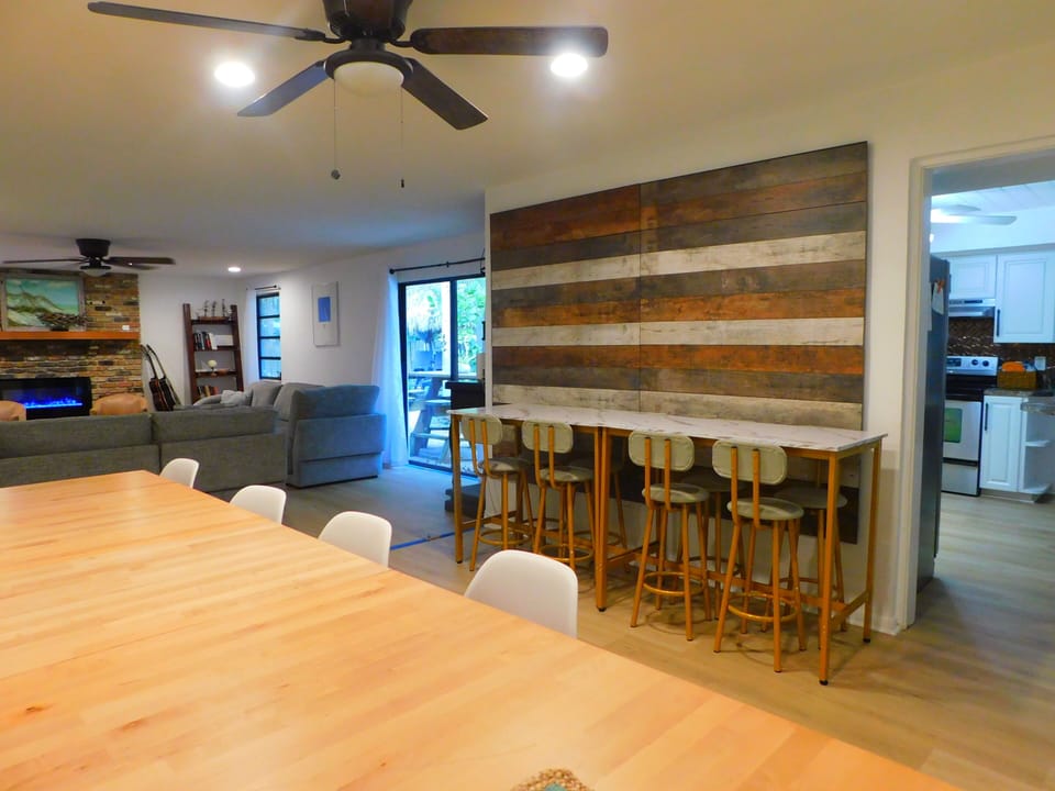 Plenty of dining seats here at lLarge house. Whiteboard too.