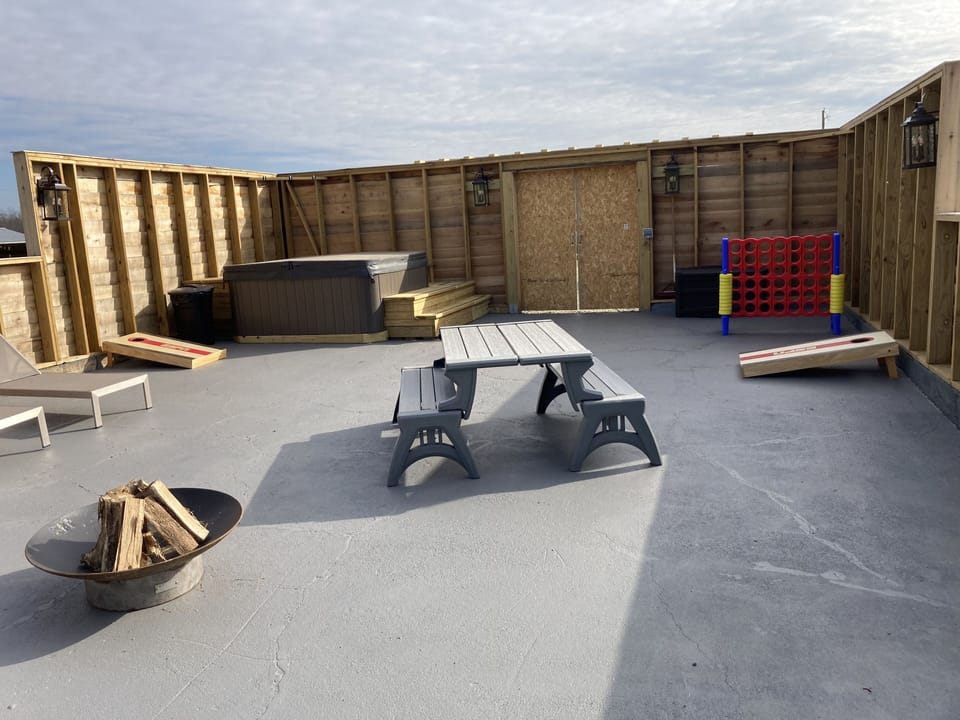 Firepit, Picnic table. corn hole. Other games and lounge furniture.  Hot tub.  