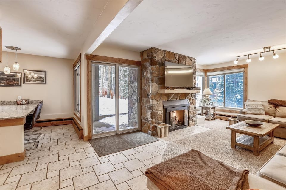 Living area with gas fireplace - Open concept living area and kitchen with patio out the glass sliding door