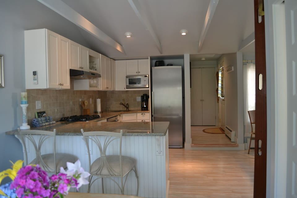 Kitchen features stainless appliances with eat in kitchen bar